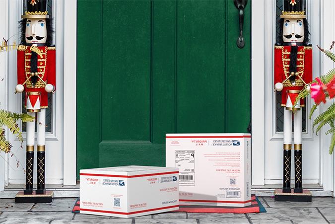 Priority Mail boxes on a house porch awaiting pickup.